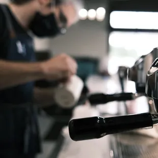 a bari preparing a cup of coffee