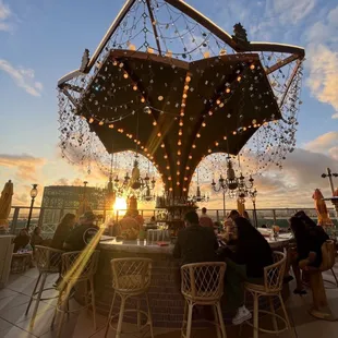 a group of people sitting at a table on a rooftop