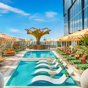 a pool with lounge chairs and umbrellas