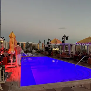 a pool and lounge area at night