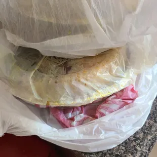 a sandwich wrapped in plastic