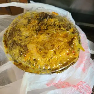 a pizza wrapped in plastic