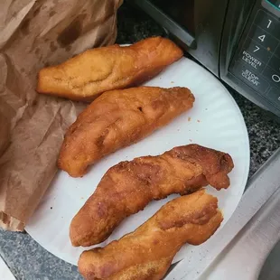 fried bread sticks on a paper plate
