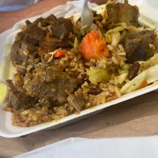 Curry Goat, Rice and peas and steamed vegetables