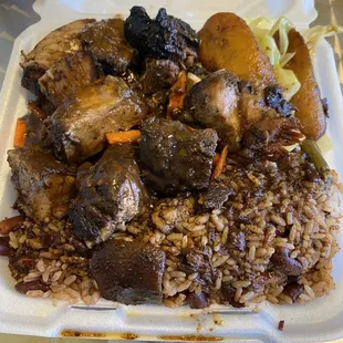Jerk pork dinner with cabbage and fried plantains.