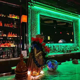a bar with green lights