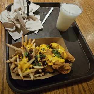 a tray of fries and a glass of milk