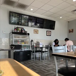 two people sitting at a table in a restaurant