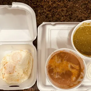 Eggs over medium, refried beans and green salsa on the side for chilaquiles.