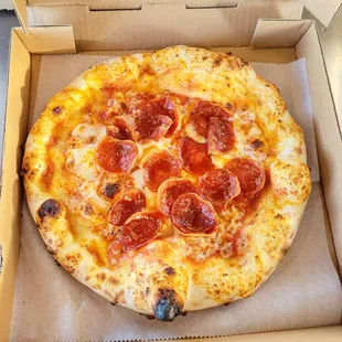 a pepperoni pizza in a box