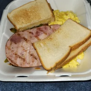 Ham and scrambled eggs, with country potatoes and toast.