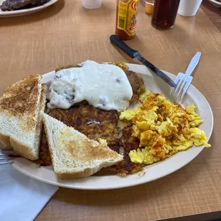 Breakfast of champions -  chicken fried steak, crispy hash browns, eggs smothered with Cholula sauce and toast. Yum.