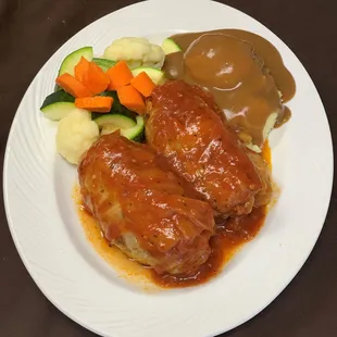 Stuffed Cabbage (Golabki) filled w/ground chuck ,rice ,sauté onion &amp; sauté green bell peppers topped with homemade red sauce.
