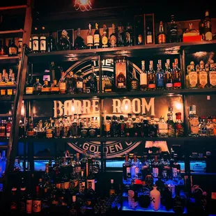 a bar with shelves full of liquor bottles