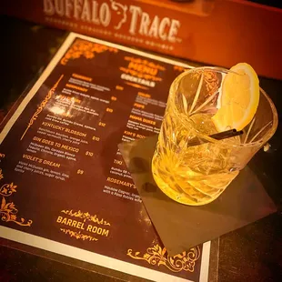 a drink and menu on a table