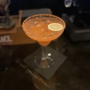 a close up of a drink in a coupe glass