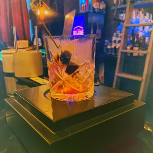 a drink in a glass on a bar