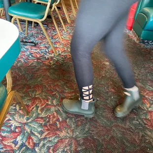 the legs of a woman in tights and high heels