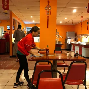 a woman serving food in a restaurant