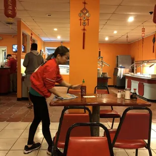 a woman serving food in a restaurant
