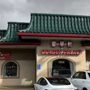 two cars parked in front of a chinese restaurant