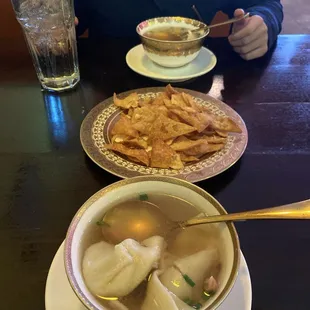 Enjoying our warm wonton soup with complimentary crispy wonton while waiting for our main entree meal.