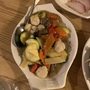 a plate of vegetables and meat on a table