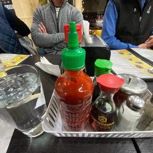 a tray of hot sauces and condiments