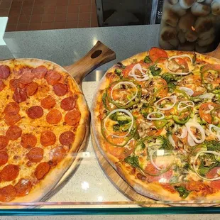 a variety of pizzas on display