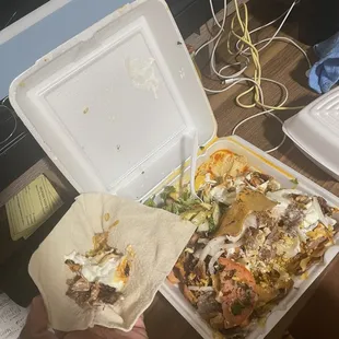 a person holding a tray of food