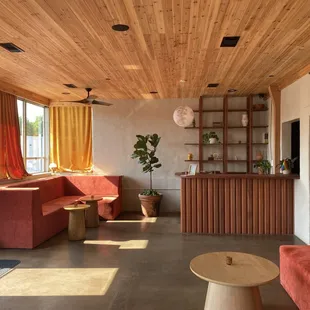 a living room with red couches