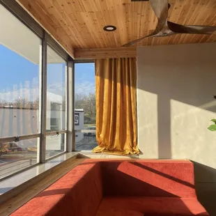 a living room with a view of the water