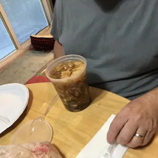 a man sitting at a table with a drink