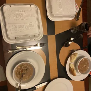 a table with soup and bread