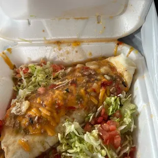 a close up of a burrito in a styrofoam container