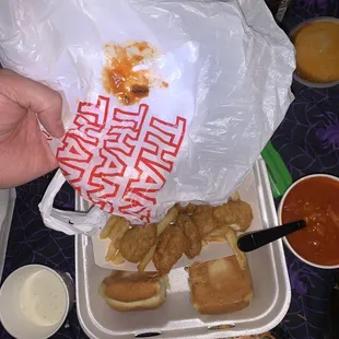 Chicken nuggets, fries, dinner roll, posole, cockroach that was in good
