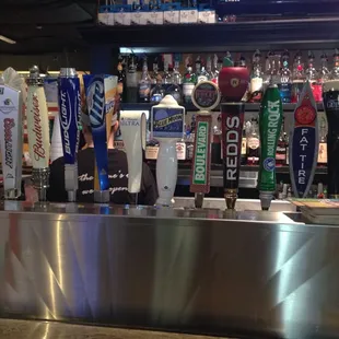 a row of beer taps in a bar