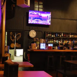 a bar with tables and a television