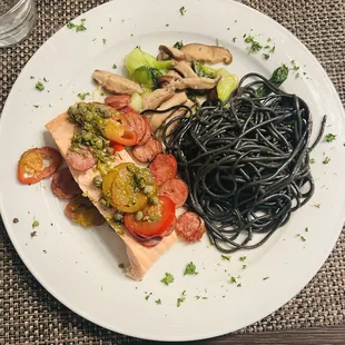 a plate of pasta, vegetables, and salmon