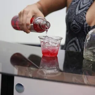 a woman pouring a drink
