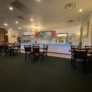 a dining area with tables and chairs