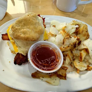Biscuit breakfast sandwich with home fries.