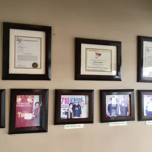 a wall full of framed photos