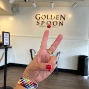 a hand with a peace sign