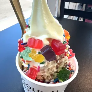 a bowl of ice cream topped with gummy bears