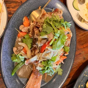 Whole fish fry with sauce poured over it