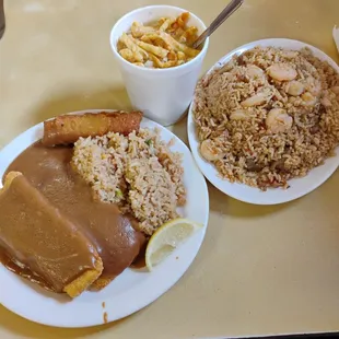 Three-piece fish with gravy on top and fried rice on the side combination fried rice shrimp and the egg drop soup with crunchies.