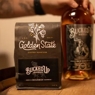 a bag of coffee and a bottle of bourbon