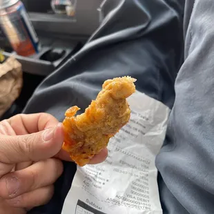 a person holding a piece of food
