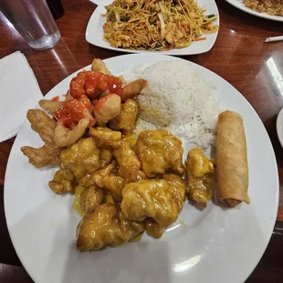Orange chicken,  sweet sour chicken, spring roll with steam white rice. Spicy Chicken lo mein in the back